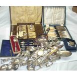 A box containing a quantity of silver plated items including cased and loose cutlery, grape