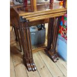 A quartetto set of brass strung mahogany nesting tea tables, set on slender turned supports