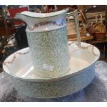 An early 20th Century toilet jug and bowl, with transfer-printed green mosaic and floral swag