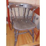 A 20th Century stained mixed wood spindle back kitchen chair, set on turned supports - sold with a