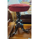 A Victorian ornate walnut piano stool with adapted upholstered top, set on triple scroll feet a/f