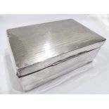 A silver clad cigarette box with cedarwood lined interior and blank cartouche to lid - dents -