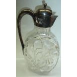 A decorative cut and textured glass claret jug with silver plated hinged lid mount and handle -