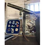 A modern brass telescope, set on turned wood tripod stand