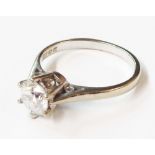 An 18ct. white gold ring, set with synthetic white stone solitaire (0.75ct.) - size L 1/2