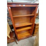 A 78cm reproduction mahogany four shelf open bookcase, set on bracket base