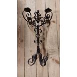A wrought iron five branch table candelabrum with scrolling decoration and black painted finish