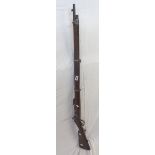 An 1886 Portuguese Kropatschek 8mm bolt-action rifle with original wood stock, serial mark TT447