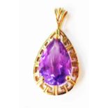 A 375 (9ct.) gold pendant, set with peardrop cut amethyst