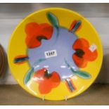 A Poole Pottery dish with stylised painted flowerheads in a bold colour palette