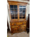 A 1.14m late Georgian mahogany, cross banded and strung secretaire/bookcase with shelves enclosed by