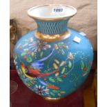 A large French pottery vase with hand painted enamels depicting an exotic bird amidst foliage on a