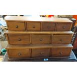 A 61cm mahogany stepped chest with an array of ten drawers and brass knob handles
