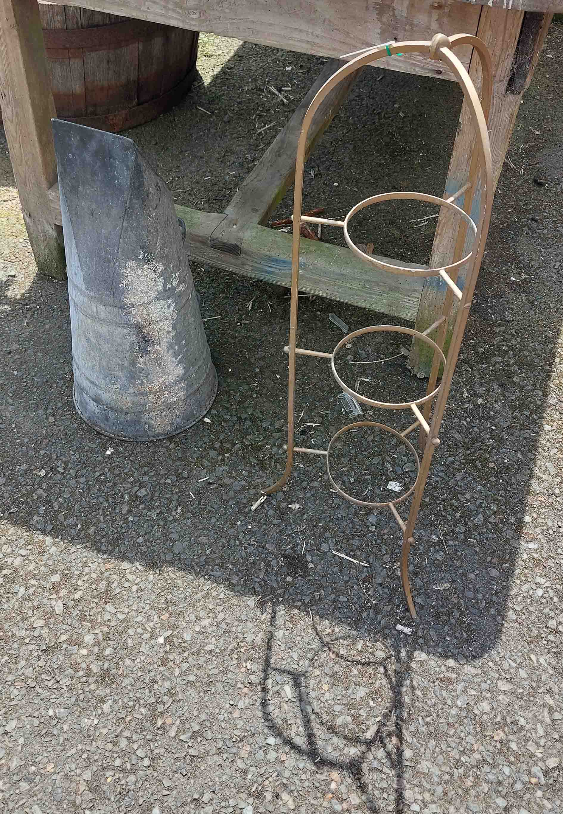 A vintage metal three tier plant stand and a coal scuttle