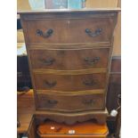 A 50cm reproduction mahogany and cross banded serpentine front chest of four long drawers, set on