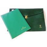 A vintage Rolex branded green plastic notepad folder and similar folio case