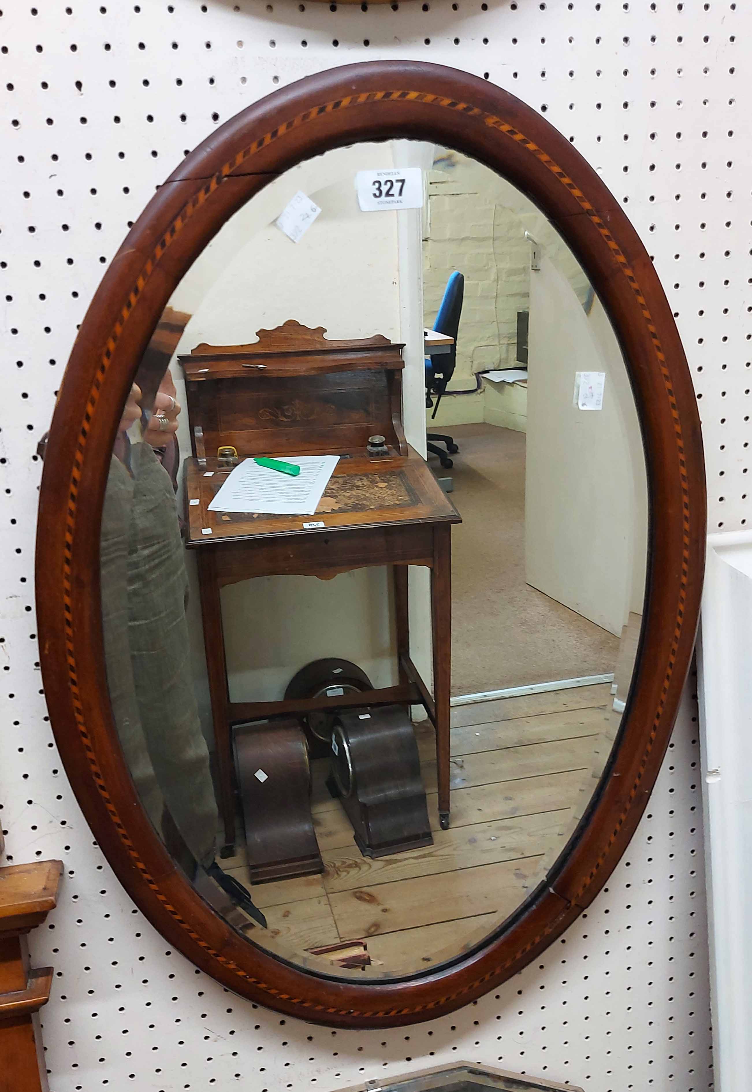 Three assorted wall mirrors comprising an Edwardian inlaid framed bevelled oval, a vintage frameless