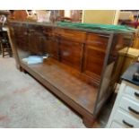 A 1.83m vintage commercial shop display cabinet with brass beaded glazing enclosing glass shelves