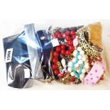 A bag containing a quantity of assorted costume jewellery - sold with a cased set of silver plated