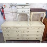 A 1.42m 20th Century French style cream and parcel gilt bedroom chest with an array of nine drawers,