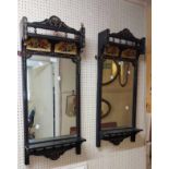 A pair of decorated ebonised framed Aesthetic Movement pier mirrors with hand painted floral