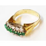 An 18ct. gold ring, set with central row of six emeralds flanked by two rows of five diamonds,