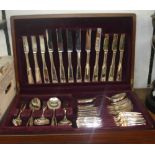 A mahogany canteen containing a part set of Viners silver plated cutlery