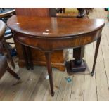 A 94cm George III mahogany semi-circular fold-over tea table, set on square tapered legs with
