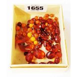 A small quantity of amber jewellery comprising two necklaces and a pendant