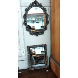 A 20th Century cast and pierced brass framed oval wall mirror - sold with an ornate resin framed