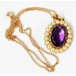 A yellow metal oval pendant (brooch conversion), set with central oval amethyst within a pearl