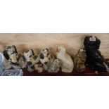Seven old Staffordshire pottery dogs including sponge decorated, painted and black glazed examples