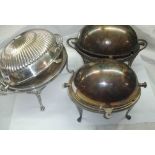 Three silver plated roll-top breakfast dishes including one with semi-reeded lid and cast paw feet -