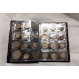 A coin collector's wallet containing a quantity of silver and other coins, including Maundy penny,