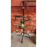 An old brass hanging oil lamp - sold with a wrought iron stand