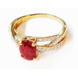 A 375 (9ct.) gold ring, set with central oval red topaz and three meandering rows of tiny diamonds -