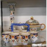 A French faience candlestick of classical column form and a similar egg holder - sold with a