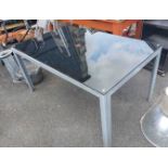 A metal framed glass topped garden table
