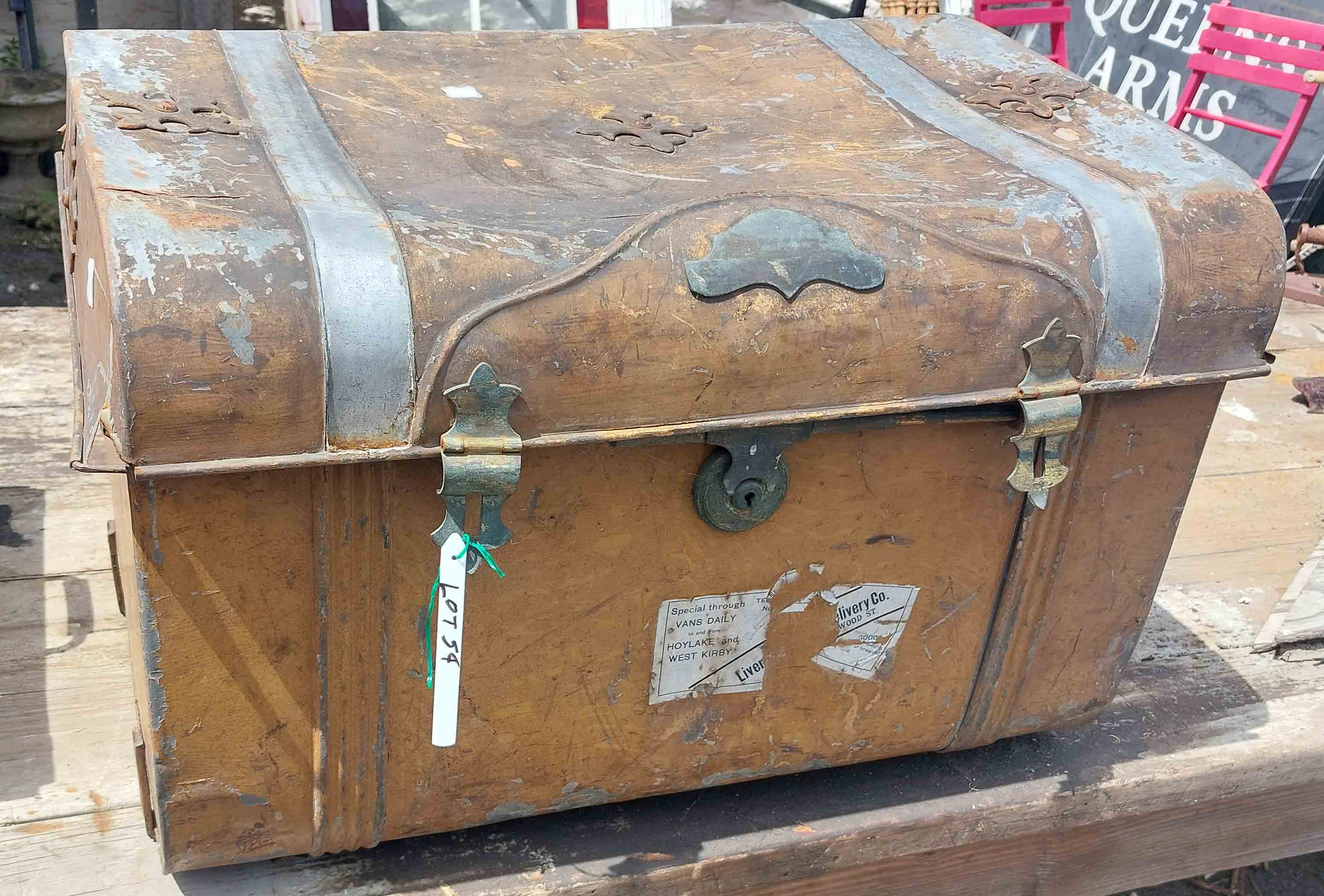 A vintage metal travelling trunk containing a selection of items including decorative metal box,
