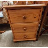 A 46cm modern pine three drawer bedside chest