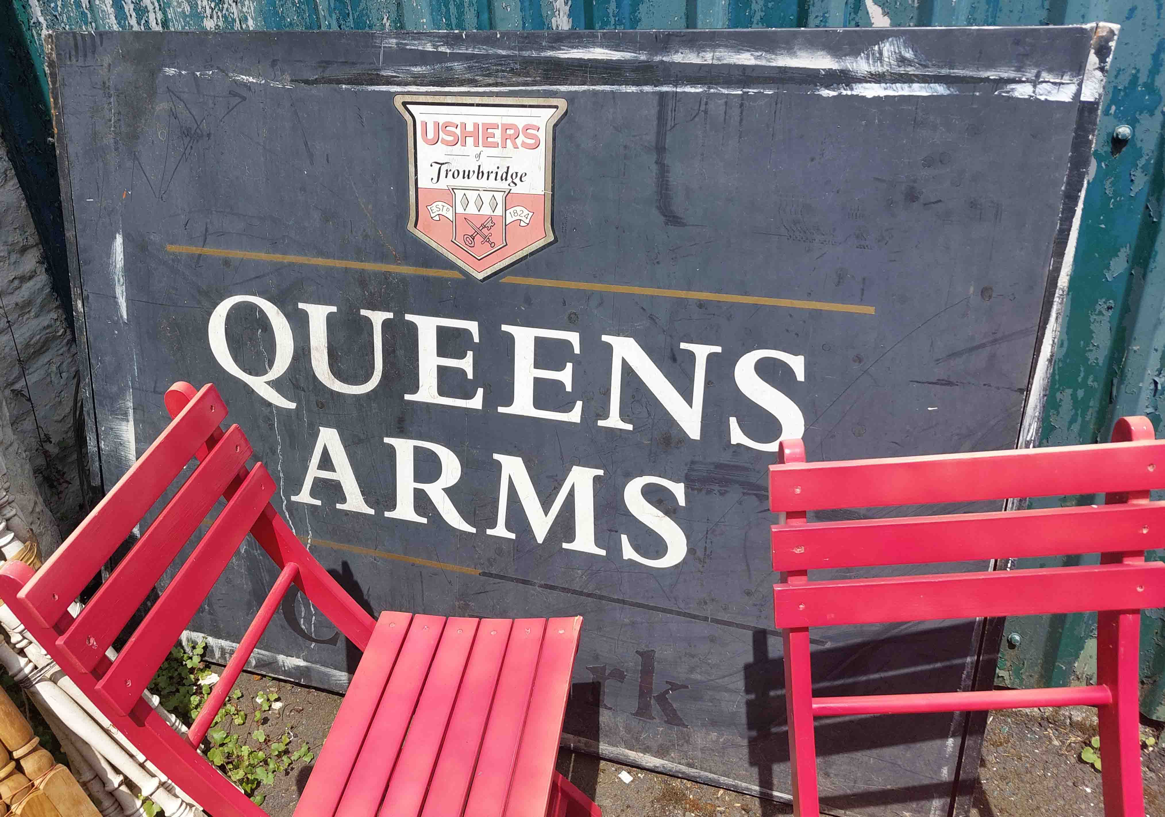 A vintage Usher metal pub sign called 'The Queens Arms'