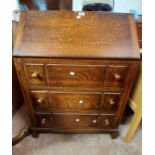 A 77cm vintage oak bureau with part fitted interior and three long drawers under, set on block feet