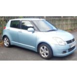 A 2007 Suzuki Swift VVTS GLX five door hatchback in pale metallic blue with alloy wheels and