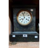A late Victorian black slate cased mantel clock with eight day gong striking movement - glass