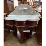 A 92cm Victorian shaped marble topped washstand, set on a mahogany duchess base with acanthus
