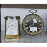 An old brass and bevelled glass cased carriage alarm clock with eight day bell striking movement -