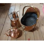 A copper coal scuttle of helmet form with brass legs and handle - sold with a copper kettle and an