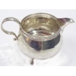 A silver cream jug with C-scroll handle and pierced rim - Birmingham