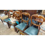 A set of four Victorian mahogany balloon back dining chairs with upholstered drop-in seats, set on