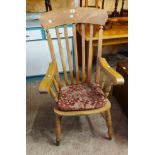 A 20th Century stripped wood Windsor high lathe back elbow chair with moulded solid elm seat, set on